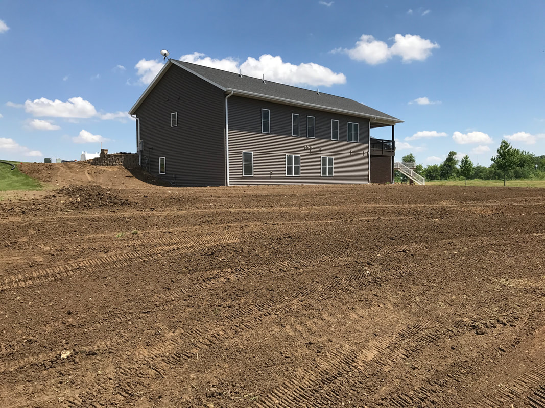 Downspout installation into the ground at a new home construction in Cascade, Iowa.